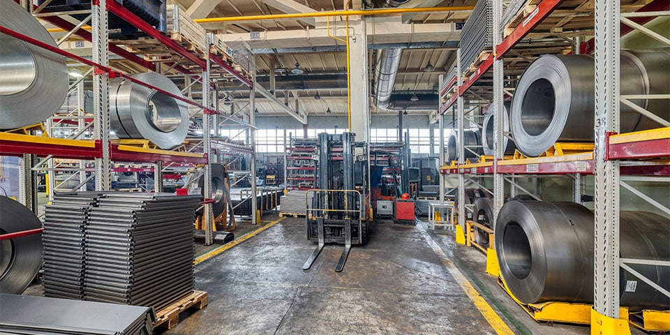 Tiered rack with sheet metal rolls. Internal warehouse of raw materials